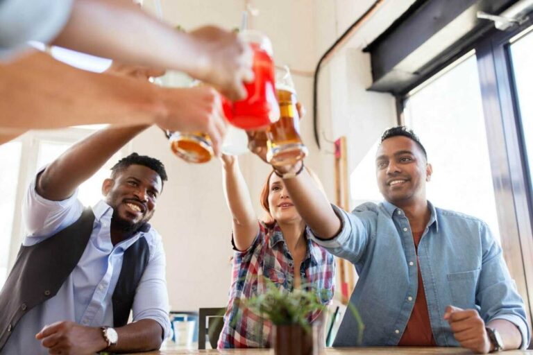 Friends Clinking Glasses With Drinks At Restaurant 768x512